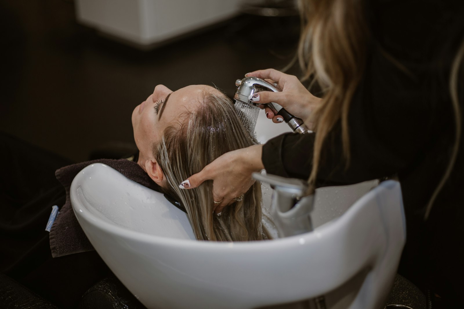 Hair stylist working in a modern salon — marketing for hair salons and barbershops